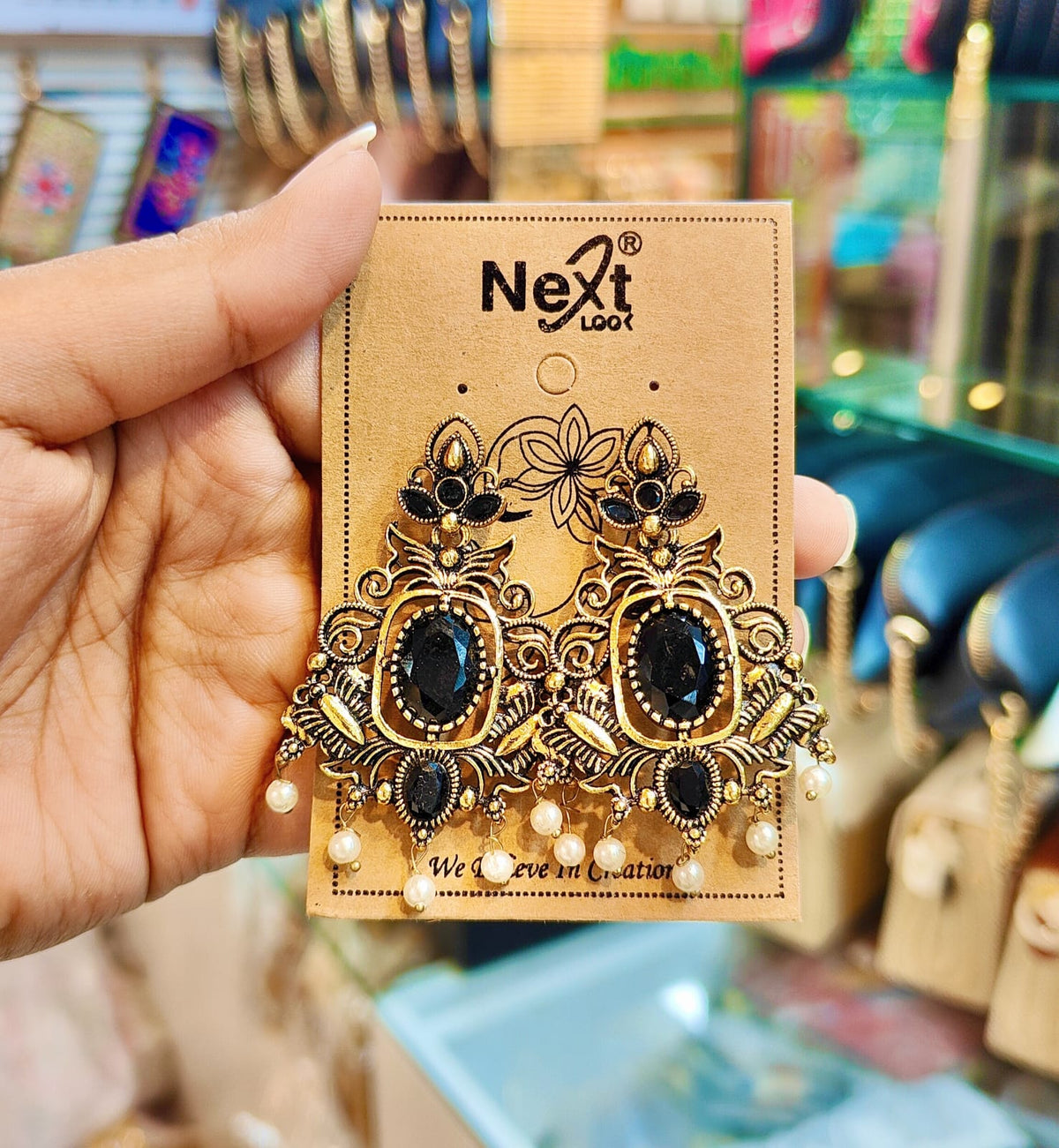 Antique-style metal drop earrings featuring a classic black stone and pearl (Antique Gold Black Stone Earrings)
